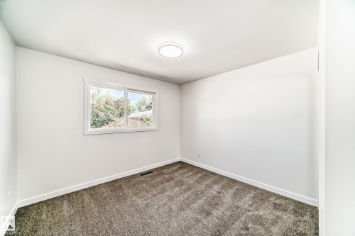 Room with light gray carpet, white walls, and white trim - 4842 116Ave, Edmonton, AB - Indoor Photo Showing Other Room