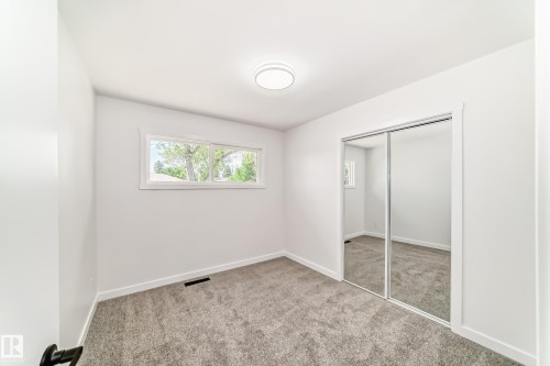 Bright interior with plush gray carpeting and white trim - 4842 116Ave, Edmonton, AB - Indoor Photo Showing Other Room