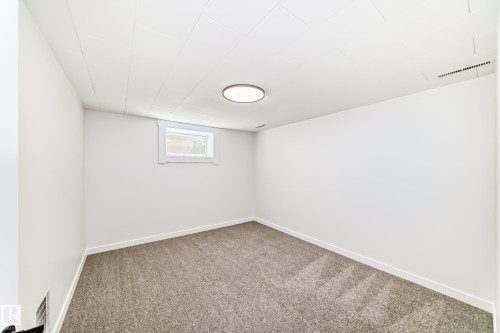Carpeted room with white painted walls and trim - 4842 116Ave, Edmonton, AB - Indoor Photo Showing Other Room