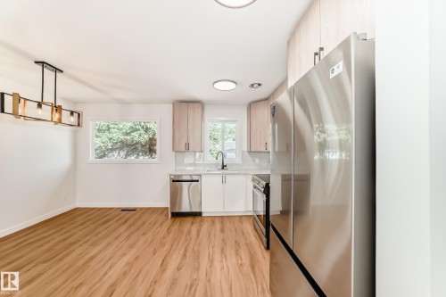 Open-concept living area with wood-finish flooring - 4842 116Ave, Edmonton, AB - Indoor Photo Showing Kitchen
