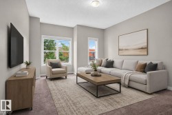 Expansive living area featuring light neutral wall tones and plush carpeting - 