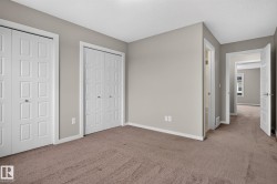 Spacious room with plush brown carpeting and light gray wall paint - 