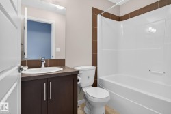 Bathroom with a white bath and shower combination unit - 