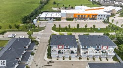 Aerial perspective highlighting multi-story townhomes with individual garage bays and balconies - 