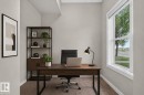 Dedicated office space featuring a large window, neutral wall paint, and carpeted flooring - 57 3710 Allan Drive, Edmonton, AB 