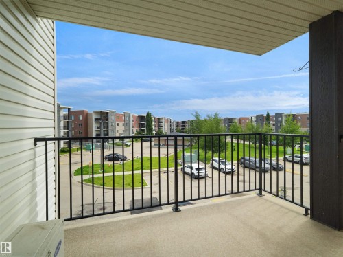 Private balcony featuring a concrete floor and black metal railing - 313 11820 22 Avenue, Edmonton, AB 