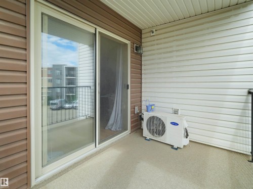 Private balcony featuring durable siding and a sliding glass door - 313 11820 22 Avenue, Edmonton, AB 