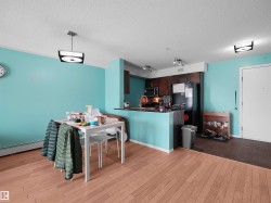 Open concept living space featuring wood-finish flooring in the main area and contrasting tile flooring near the entry - 