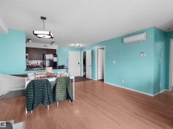 Open-concept living space with wood-finish flooring - 