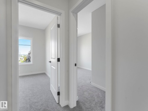 Neutral gray wall finishes throughout, complemented by white trim and doors - 1717 Crossbill Loop, Edmonton, AB - Indoor Photo Showing Other Room