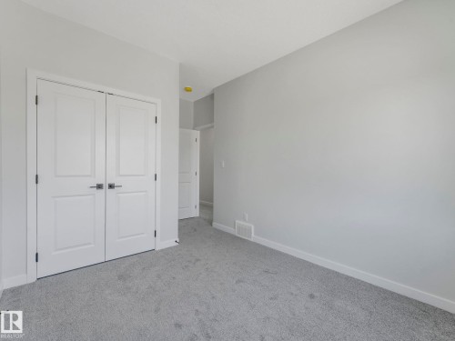Interior room with light gray carpeting and light gray wall paint - 1717 Crossbill Loop, Edmonton, AB - Indoor Photo Showing Other Room