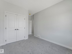 Interior room with light gray carpeting and light gray wall paint - 