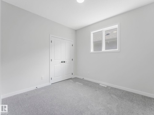 Neutral gray wall paint and light gray carpeting - 1717 Crossbill Loop, Edmonton, AB - Indoor Photo Showing Other Room