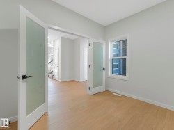 Room featuring light wood-finish flooring, a white window frame, and neutral wall paint - 