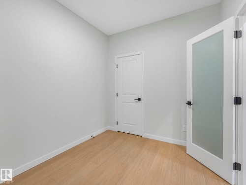 Room featuring light wood-finish flooring and neutral wall tones - 1717 Crossbill Loop, Edmonton, AB - Indoor Photo Showing Other Room
