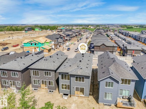 Newly constructed residential property featuring gray siding and a dark shingle roof - 1717 Crossbill Loop, Edmonton, AB - Outdoor