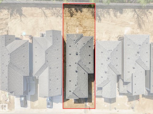 Aerial perspective showcasing a single-family residence with a dark shingle roof, a rectangular lot, and an undeveloped rear yard - 1717 Crossbill Loop, Edmonton, AB - Other
