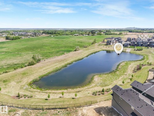 Pond with naturalized banks surrounded by expansive green spaces - 1717 Crossbill Loop, Edmonton, AB - Outdoor With View