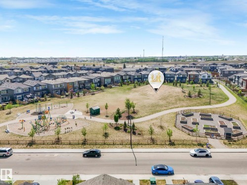 Community park featuring a playground, walking paths, and raised garden beds - 1717 Crossbill Loop, Edmonton, AB - Outdoor With View
