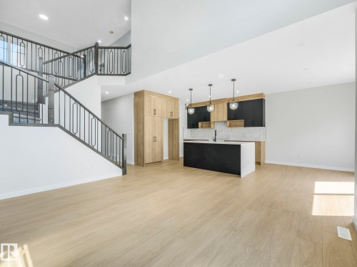 Open-concept living space with light wood-finish flooring - 1717 Crossbill Loop, Edmonton, AB - Indoor Photo Showing Kitchen