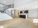 Open-concept living space with light wood-finish flooring - 1717 Crossbill Loop, Edmonton, AB  - Indoor Photo Showing Kitchen 