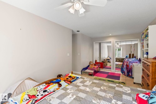 Neutral wall paint, ceiling fan, recessed lighting, and mirrored closet doors - 860 41 Avenue, Edmonton, AB 