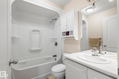 Bathroom featuring a white bathtub and shower surround with integrated shelving - 860 41 Avenue, Edmonton, AB 