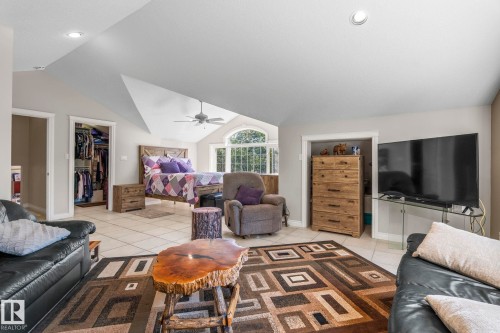 Spacious room featuring vaulted ceilings, recessed lighting, and light-toned tile flooring - 860 41 Avenue, Edmonton, AB 