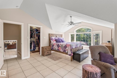 Vaulted ceiling with an arched window, tile flooring, and a ceiling fan - 860 41 Avenue, Edmonton, AB 
