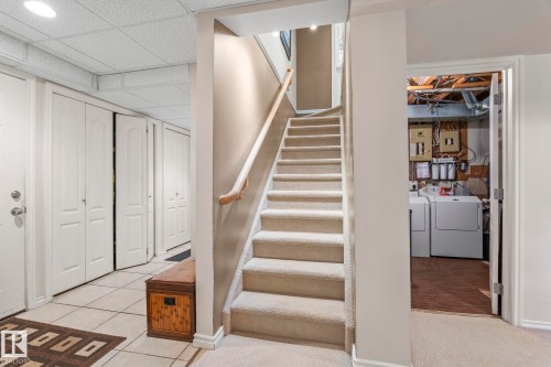 Carpeted staircase with wooden handrail - 860 41 Avenue, Edmonton, AB 