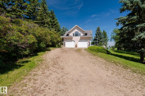 Two-story residence featuring a neutral-toned exterior, an arched window, and a gray shingle roof - 860 41 Avenue, Edmonton, AB 