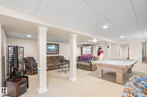 Spacious lower-level entertainment area featuring recessed lighting, a drop-panel ceiling, and light-toned carpeting - 860 41 Avenue, Edmonton, AB 