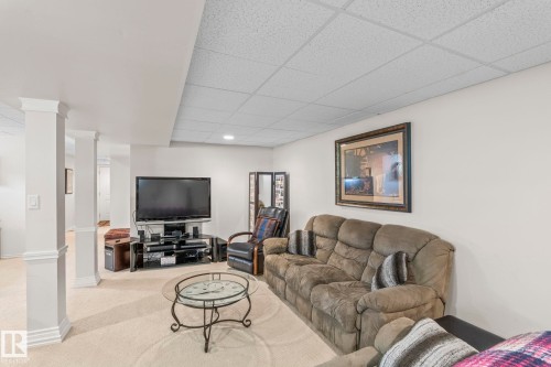 Finished lower level with carpet flooring, recessed lighting, and a drop ceiling - 860 41 Avenue, Edmonton, AB 