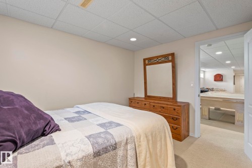 Recessed lighting illuminates a space featuring light-colored walls and a drop ceiling - 860 41 Avenue, Edmonton, AB 