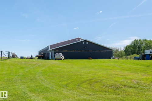 Expansive green lawn fronting a large dark-sided outbuilding with a brown roof - 860 41 Avenue, Edmonton, AB 