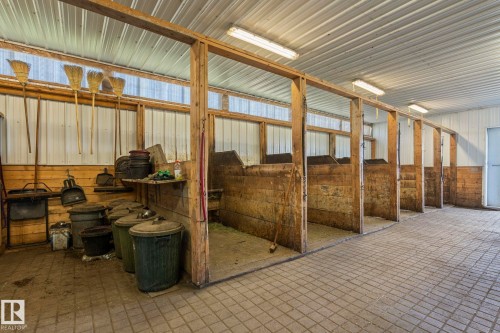 Multi-stall interior barn space featuring wood-frame construction and corrugated metal walls - 860 41 Avenue, Edmonton, AB 