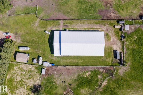 Expansive property featuring a large white-roofed structure, several outbuildings, and extensive fenced areas - 860 41 Avenue, Edmonton, AB 