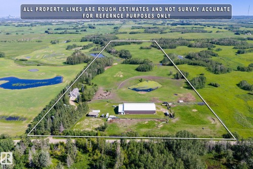 Expansive aerial property featuring a main residence, a large outbuilding, and significant open land - 860 41 Avenue, Edmonton, AB 