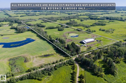 Expansive acreage featuring a large outbuilding with a metal roof, multiple ponds, and abundant green space - 860 41 Avenue, Edmonton, AB 