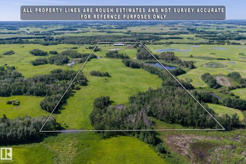 Expansive land parcel featuring open fields, wooded areas, and scattered ponds - 860 41 Avenue, Edmonton, AB 