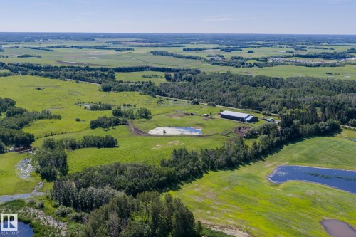 Expansive land parcel featuring open fields, wooded areas, and multiple water bodies - 860 41 Avenue, Edmonton, AB 