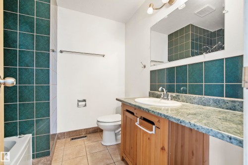 Bathroom featuring a wood vanity with a light-colored countertop and an integrated sink - 14916 114A Street, Edmonton, AB 