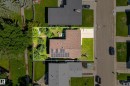 Brown shingle roofing with installed solar panels - 14916 114A Street, Edmonton, AB 