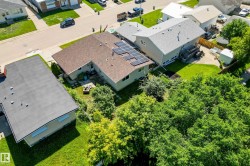 Aerial perspective highlighting the property's roofline with solar panels - 