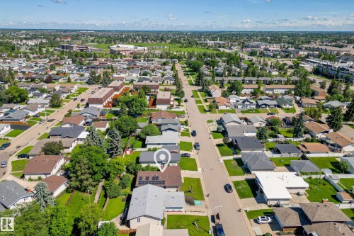 Aerial perspective showcasing the subject property with solar panels, a paved driveway, and mature landscaping within a residential setting - 14916 114A Street, Edmonton, AB 
