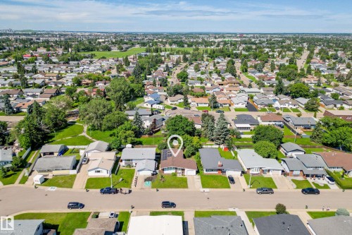 Suburban neighborhood with mature trees and a mix of single-story residences - 14916 114A Street, Edmonton, AB 