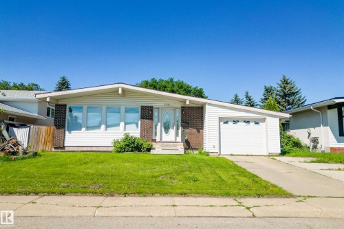 Ranch-style residence featuring white horizontal siding, brick accents, and an attached single-car garage - 14916 114A Street, Edmonton, AB 