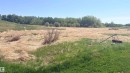 Expansive open land featuring diverse vegetation, a clear sky, and a distant tree line - 458 20212 Twp Road 510, Rural Strathcona County, AB 