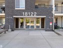 Modern multi-level building with stacked stone facade and concrete walkways - 410 18122 77 Street, Edmonton, AB 