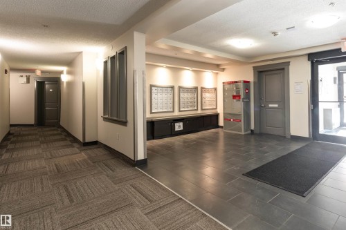 Community lobby featuring a textured ceiling - 317 11441 Ellerslie Road, Edmonton, AB 